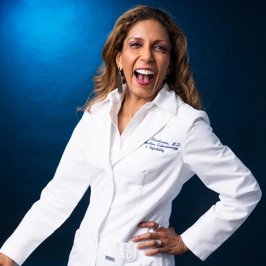 Dr. Noorhasan mid-talk in her white coat